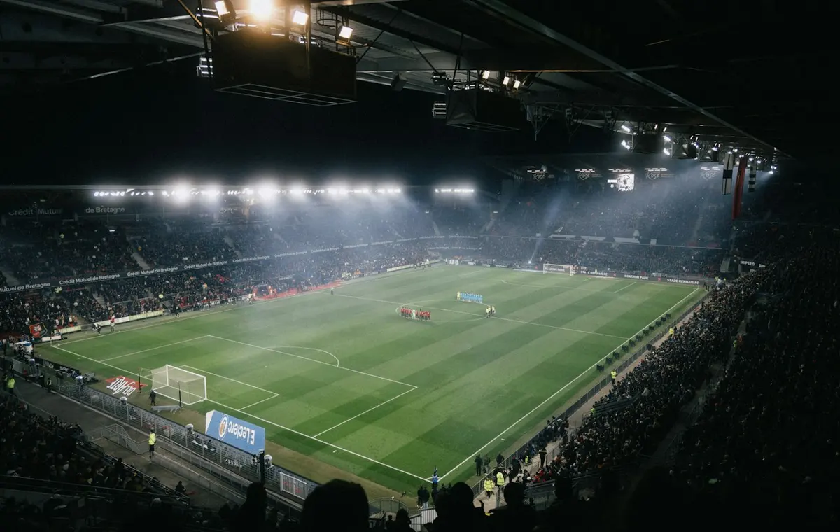 A floodlit football stadium on a match night